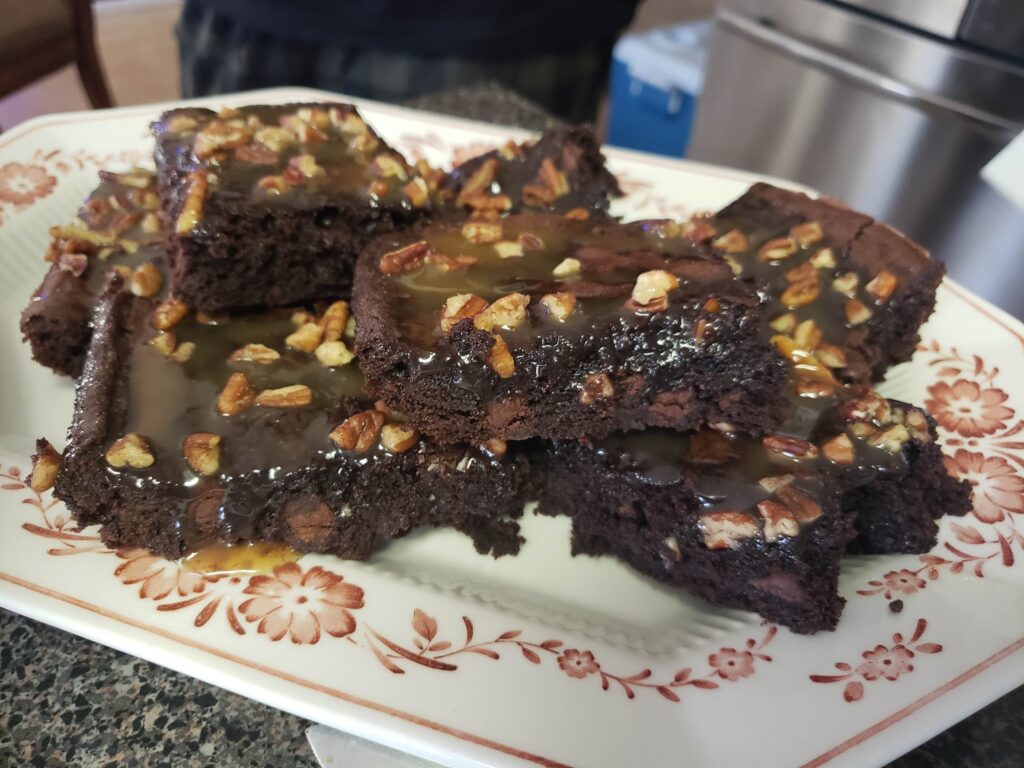 Brownie topped with caramel and pecans